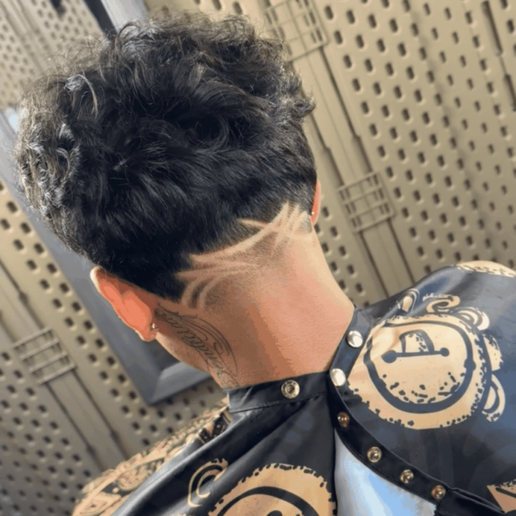 Detailed custom surgical line hair design on a men's taper fade, expertly crafted at Cutthroat Barbershop in Spokane, WA.