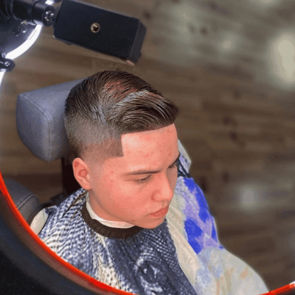 Side profile of a precision men's taper fade and sharp lineup performed at Cutthroat Barbershop Spokane.