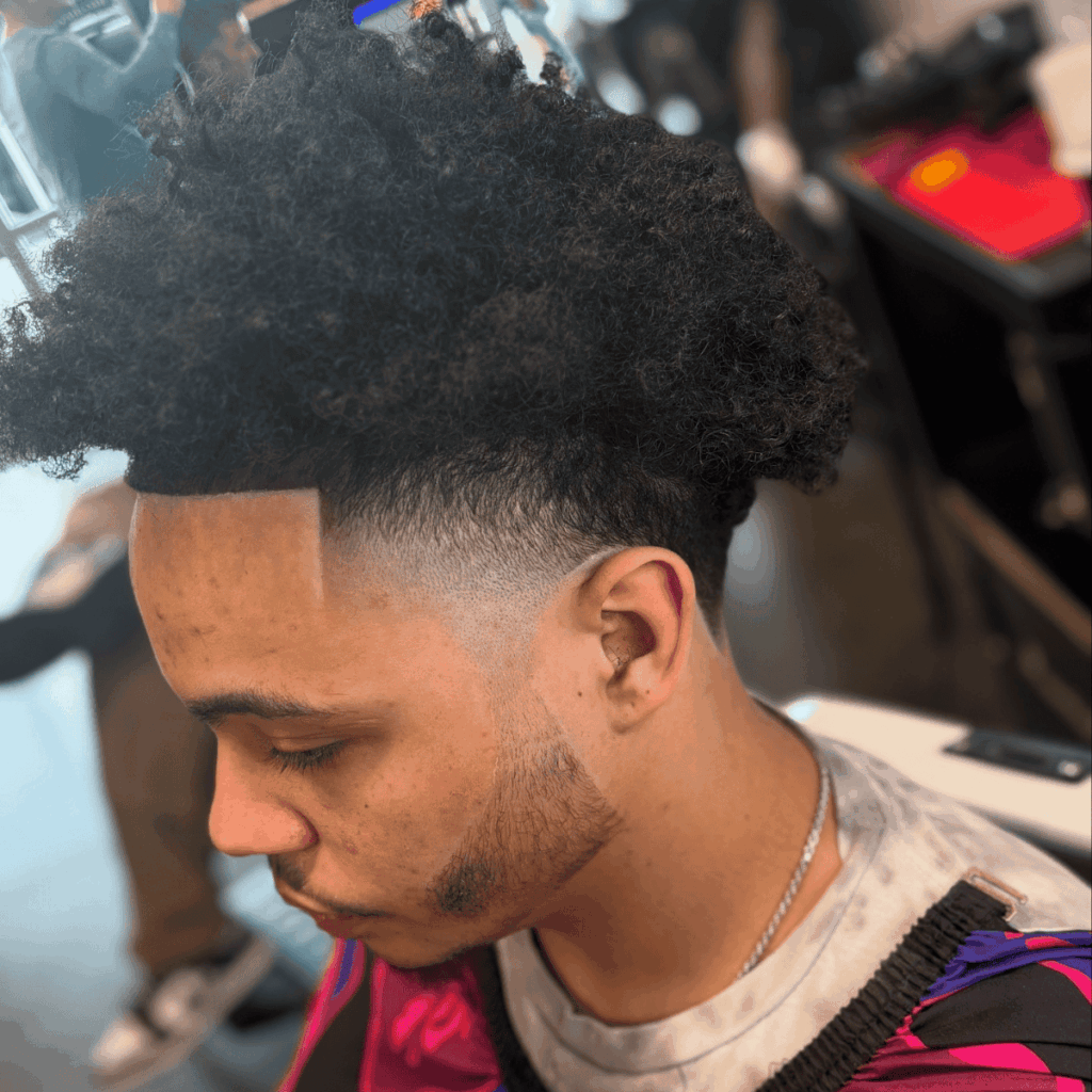 Detailed view of a high-taper fade with a precision lineup and textured natural top, performed by a professional barber at Cutthroat Barbershop in Spokane.