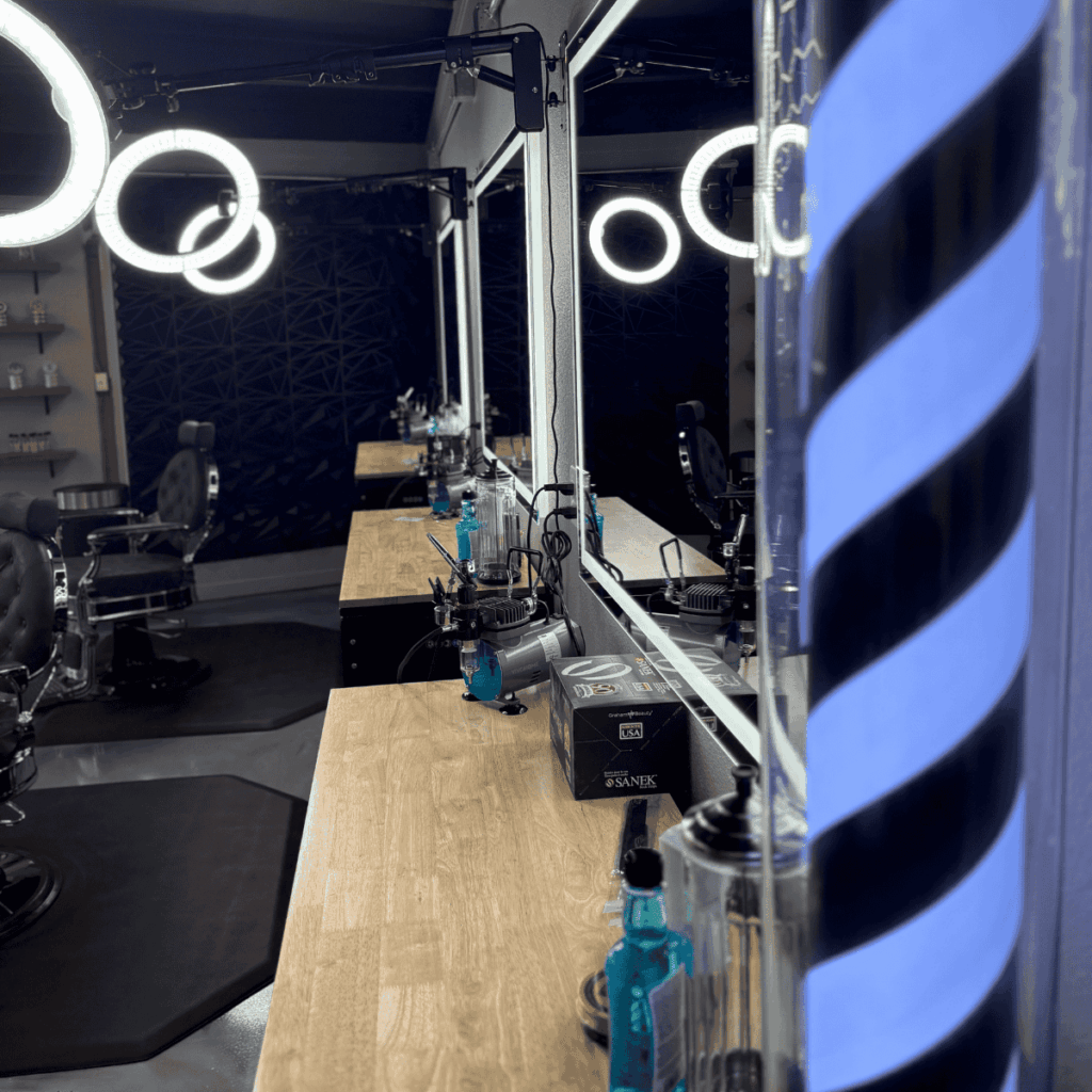 Modern industrial barbershop interior with custom honeycomb LED ceiling lights in Spokane