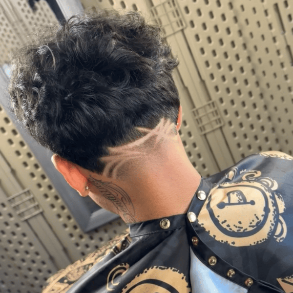Detailed custom surgical line hair design on a men's taper fade, expertly crafted at Cutthroat Barbershop in Spokane, WA.