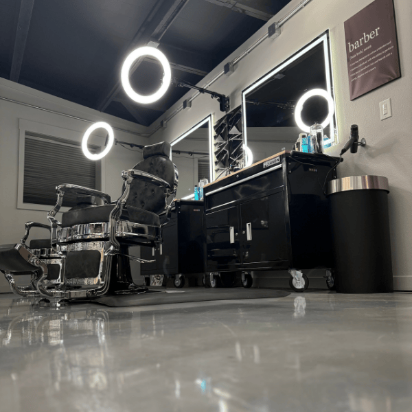 Luxury barbershop floor with polished concrete and hex lighting at Cutthroat Spokane