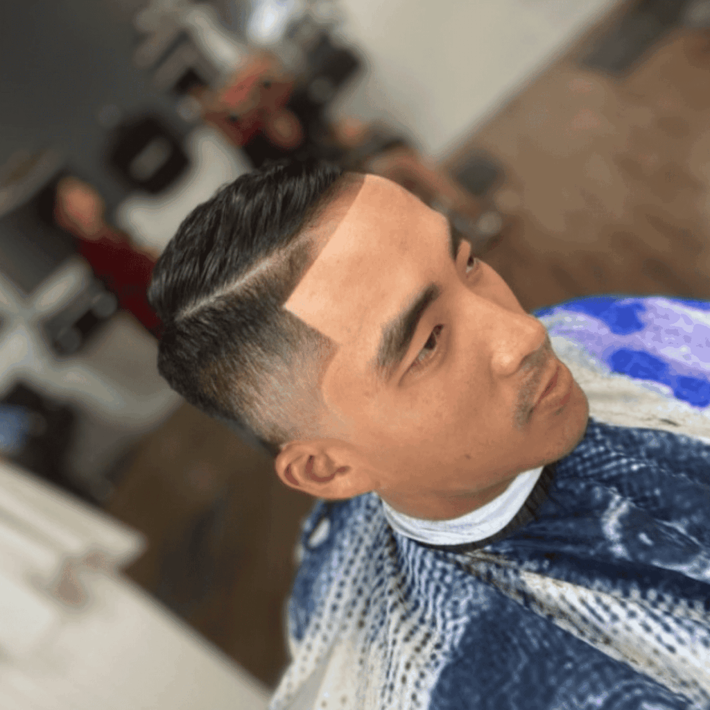 Precision skin fade haircut with hard part by Cutthroat Barbershop Spokane