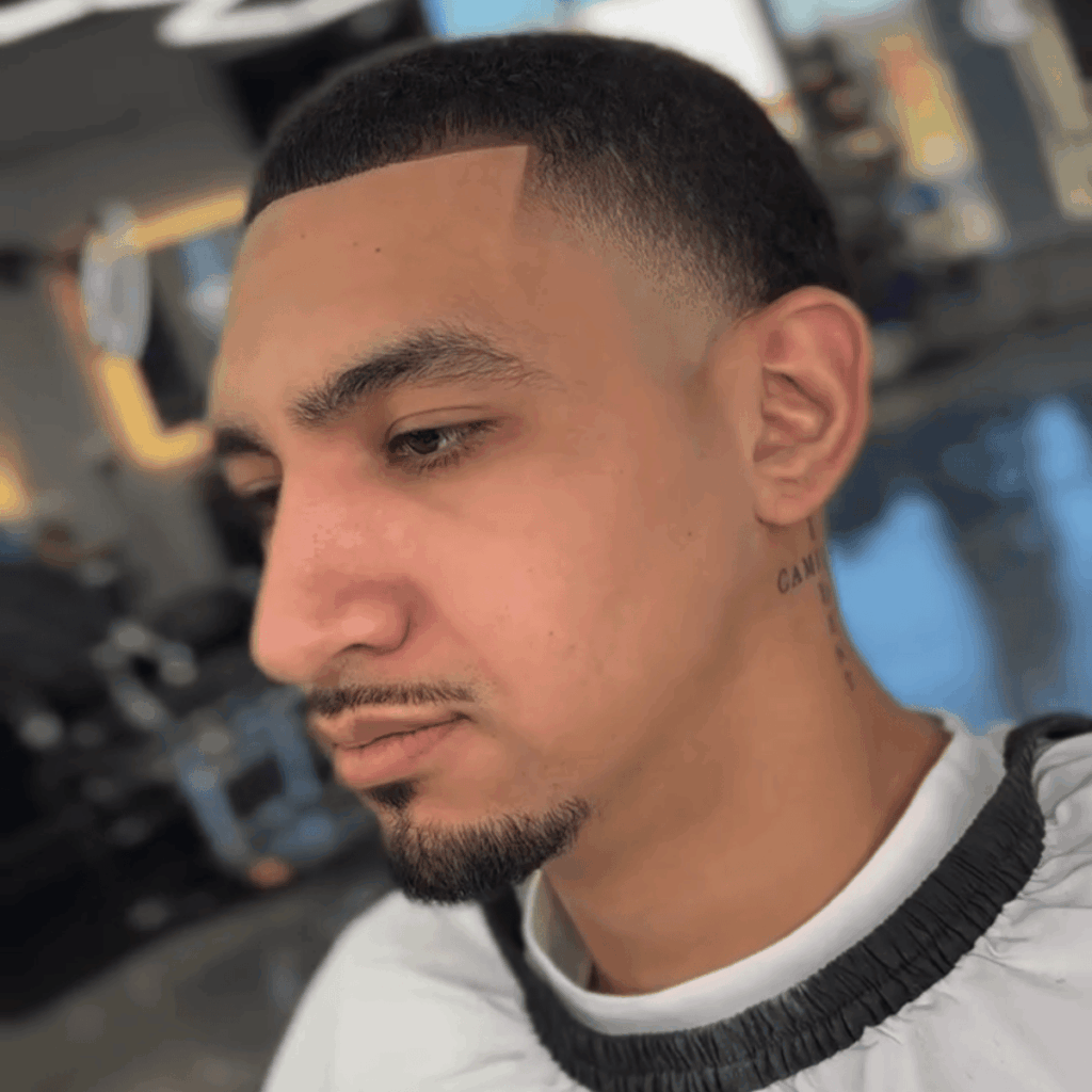 Close-up shot of a barber using professional trimmers to create a smooth, clean neck taper.